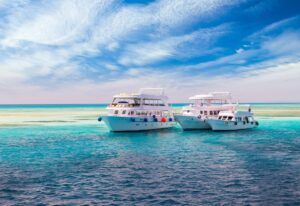 Cruise yacht bow in clear water near a coral reef. Red Sea, Egypt