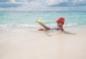 A little girl is resting on the sea. Summer nature and travel.