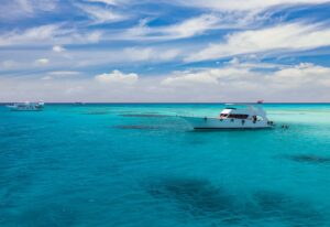 Cruise yacht bow in clear water near a coral reef. Red Sea, Egypt