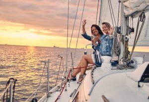 Female friends relaxing on the yacht during sunset on the high seas.