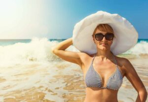Woman in hat on the beach