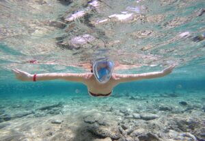 Woman snorkeling close to coral reef, Red Sea, Egypt