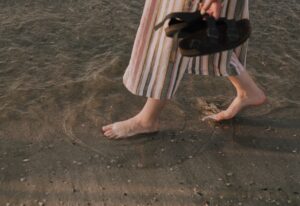 Woman walking on sand at the Beach