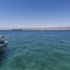 Boat moored in the Red Sea, Jordan, with coastline in the distance.