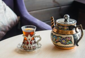 Turkish tea in traditional glass on table. Drink in national restaurant