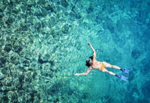 Woman snorkeling in tropical sea water