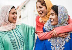 Young islamic people having fun outdoor in the city - Main focus on center woman face