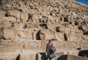 Une blonde européenne se promène près des pyramides dans le désert du Caire