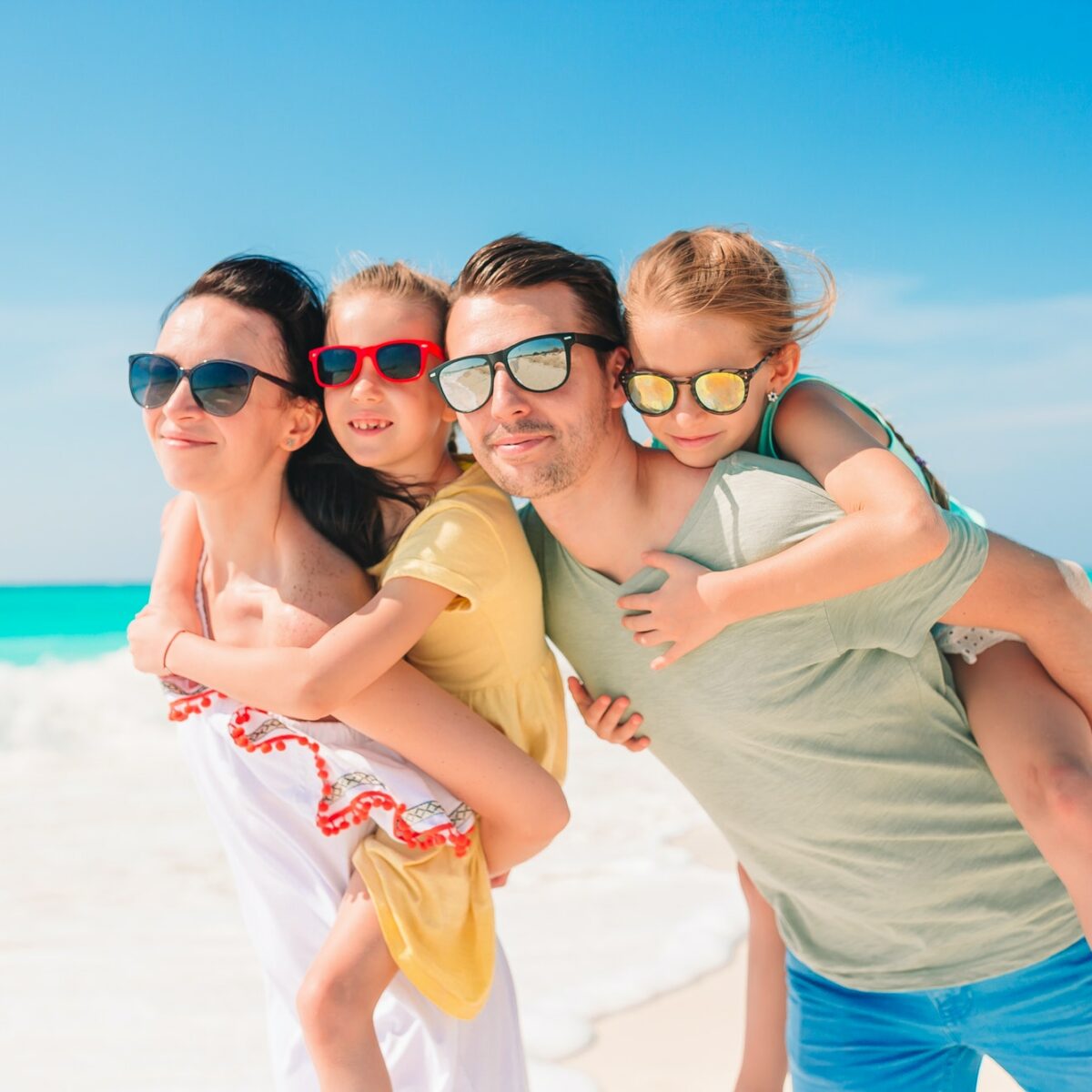 Happy beautiful family on a tropical beach vacation