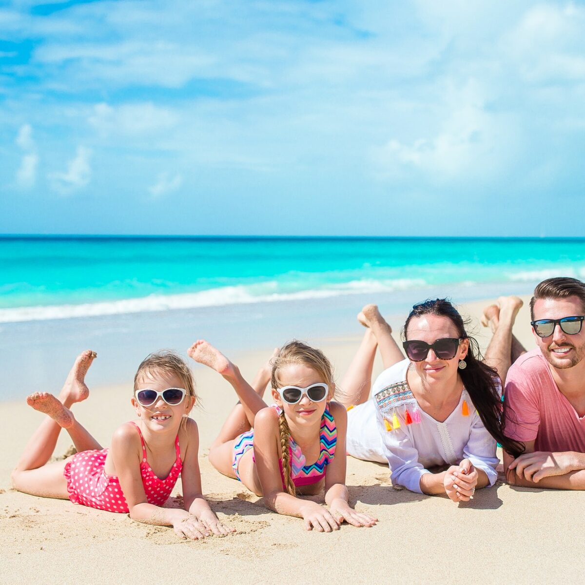 Happy family on the beach during summer vacation